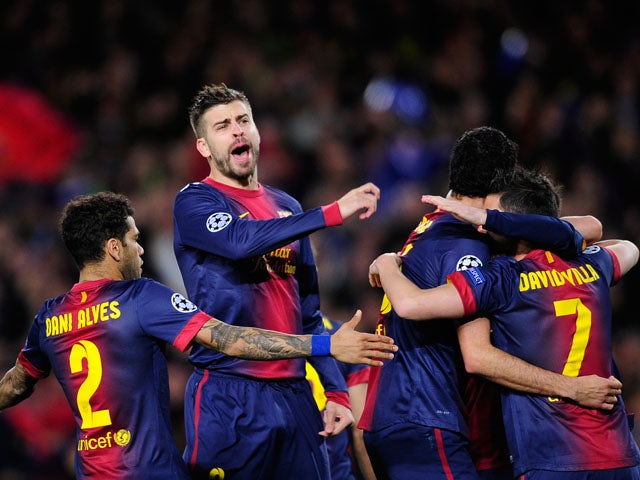 Barcelona players celebrate the opening goal in their Champions League clash against AC Milan on March 12, 2013