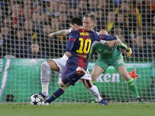Barcelona's forward Lionel Messi scores his second goal during the second leg of his side's Champions League last 16 match with AC Milan on March 12, 2013