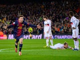 Barcelona's Lionel Messi celebrates after scoring his second goal against AC Milan on March 12, 2013