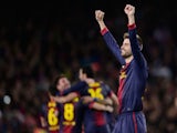 Barcelona player Gerard Pique celebrates after his side knocked AC Milan out of the Champions League on March 12, 2013