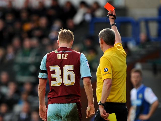 Burnley's Ben Mee is shown a red card during the Championship clash with rivals Blackburn on March 17, 2013