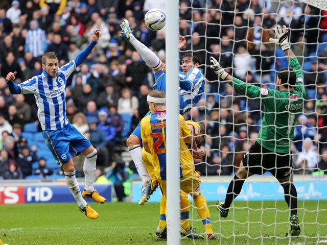 Brighton's Leonardo Ulloa leaps to score his side's first goal in their clash with Crystal Palace on March 17, 2013