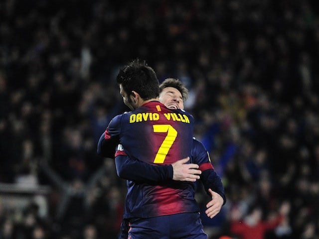 Barca forward David Villa hugs Lionel Messi after the Spaniard scored against Rayo Vallecano on March 17, 2013