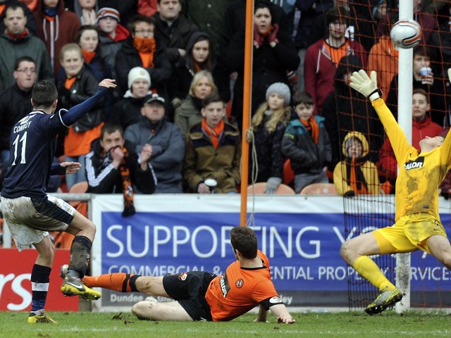 Dundee's Ryan Conroy scores during the Scottish Premier League match against Dundee United on March 17, 2013