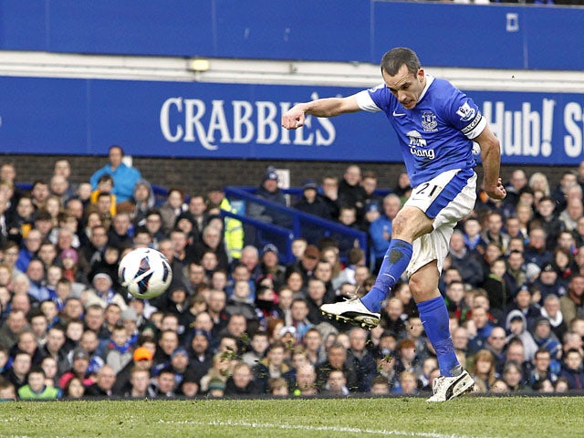 Everton's Leon Osman scores the opening goal in his side's match against Manchester City on March 16, 2013