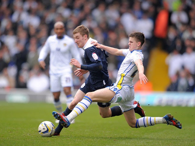 Leeds United's Samuel Byram slides in on Huddersfield Town's Paul Dixon during the Campionship clash on March 16, 2013