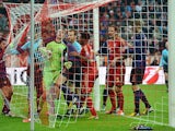 Bayern goalkeeper holds onto the ball after Arsenal's Laurent Koscielny headed in his team's second on March 13, 2013