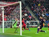Olivier Giroud scores the opening goal against Bayern Munich on March 13, 2013