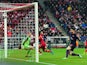 Olivier Giroud scores the opening goal against Bayern Munich on March 13, 2013
