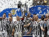 St Mirren players lift the cup after winning the Scottish League Cup final on March 17, 2013