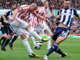 Stoke City's Jon Walters sees his shot blocked by West Bromwich Albion's Gareth McAuley during the Premier League match on March 16, 2013