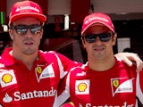 Ferrari drivers Fernando Alonso and Felipe Massa pose for a photo during the paddock of the Interlagos race track on November 22, 2012
