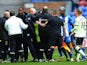 Newcastle coach John Carver is held back after having words with Wigan's Graham Barrow on March 17, 2013