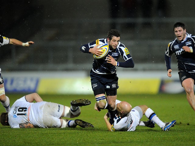 Sale Sharks' Nick Macleod is tackled by Bath's Peter Stringer during the Aviva Premiership on March 22, 2013
