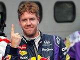 Red Bull driver Sebastian Vettel celebrates after taking pole position during qualifying of the Malaysian Grand Prix on March 23, 2013
