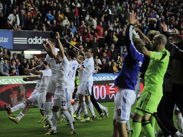 Finland players celebrate after their draw with World Champions Spain on March 22, 2013
