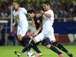 Sevilla's Alberto Botia closes down Barcelona's Lionel Messi on September 29, 2012