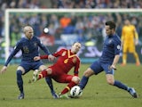 Spain's Andres Iniesta is challenged by two French players on March 26, 2013