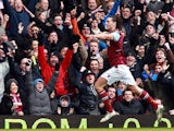 Andy Carroll celebrates after scoring the opening goal against West Brom on March 30, 2013