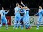 Napoli's Blerim Dzemaili is mobbed by team mates after scoring the opener against Torino on March 30, 2013
