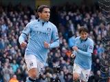Carlos Tevez celebrates scoring the opening goal against Newcastle on March 30, 2013