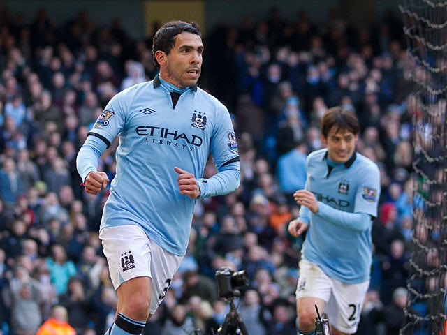 Carlos Tevez celebrates scoring the opening goal against Newcastle on March 30, 2013