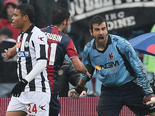 Bologna's Cianluca Curci celebrates after saving Udinese forward Antonio Di Natale's penalty on March 30, 2013