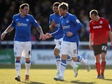 Peterborough United's Grant McCann celebrated with team mate Lee Tomlin after scoring a penalty against Cardiff on March 30, 2013