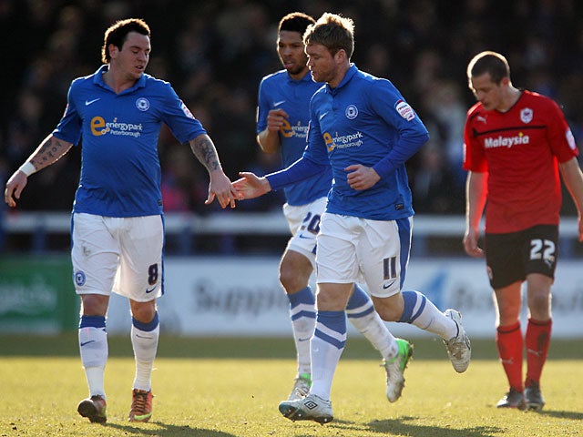 Peterborough United's Grant McCann celebrated with team mate Lee Tomlin after scoring a penalty against Cardiff on March 30, 2013