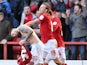 Forest's Henri Lansbury is congratulated by team mate Simon Cox after grabbing a late equaliser against Brighton on March 30, 2013
