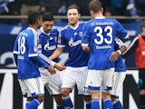 Schalke's Marco Hoeger is congratulated by team mates after scoring the opening goal against Hoffenheim on March 30, 2013