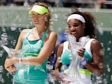 Venus Williams poses with her winner's trophy next to Maria Sharapova after claiming victory in the Miami Masters on March 30, 2013