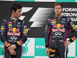 Red Bull drivers Webber and Vettel on the podium after the Malaysian GP on March 24, 2013