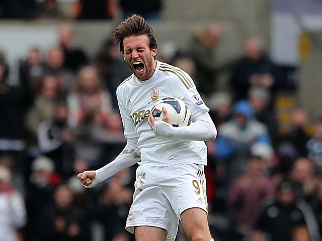 Michu celebrates moments after grabbing a goal back against Spurs on March 30, 2013