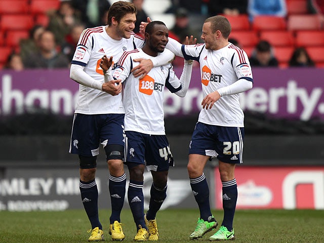 Bolton's Mohamed Kamara celebrates with team mates after scoring his team's second against Charlton on March 30, 2013