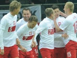 Poland players celebrate after a penalty by Robert Lewandowski in the game with San Marino on March 26, 2013