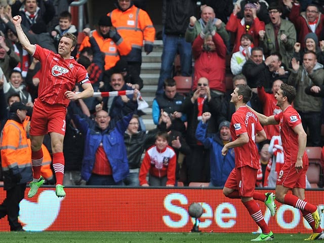 Rickie Lambert is joined by team mates as he celebrates scoring his team's second against Chelsea on March 30, 2013