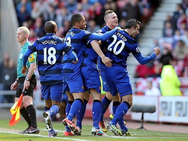 Robin Van Persie celebrates with team mates after scoring the opener against Sunderland on March 30, 2013