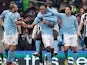 Vincent Kompany is congratulated by team mates after scoring his team's third against Newcastle on March 30, 2013