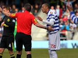 Referee Phil Dowd instructs Bobby Zamora to leave the field moments after showing him a red card in the match against Wigan on April 7, 2013