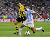 Malaga's Jeremy Toulalan fends off a challenge during his side's match against Dortmund on April 3, 2013