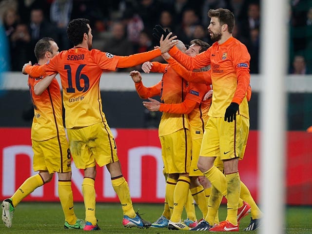 Barcelona's Lionel Messi is congratulated by team mates after scoring the opening goal against Paris Saint-Germain on April 2, 2013