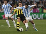 Malaga's Isco is challenged by Dortmund's Sebastian Kehl during the Champions League match on April 3, 2013