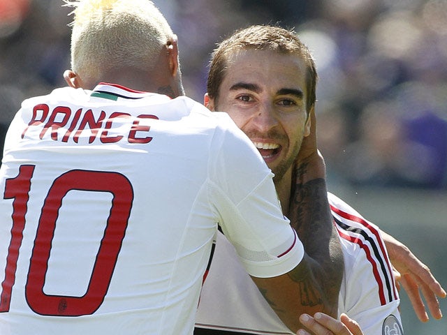 AC Milan's Mathieu Flamini is congratulated by team mates Kevin Prince Boateng after scoring his team's second against Fiorentina on April 7, 2013