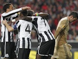 Newcastle players congratulate Papiss Cisse after his goal against Benfica on April 4, 2013