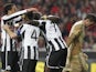 Newcastle players congratulate Papiss Cisse after his goal against Benfica on April 4, 2013