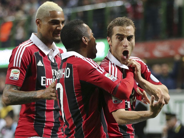 AC Milan midfielder Mathieu Flamini celebrates after scoring against Napoli during the Serie A clash on April 14, 2013