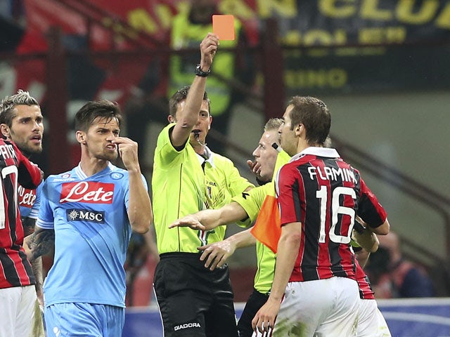 AC Milan midfielder Mathieu Flamini is shown a red card during the Serie A match with Napoli on April 14, 2013