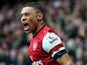 Arsenal's Alex Oxlade-Chamberlain celebrates after Norwich score an own goal and his team's third on April 13, 2013