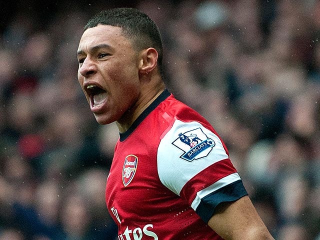 Arsenal's Alex Oxlade-Chamberlain celebrates after Norwich score an own goal and his team's third on April 13, 2013